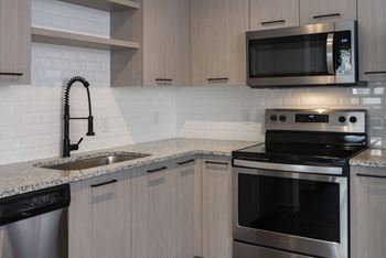 Stainless steel appliances in kitchen with cabinets